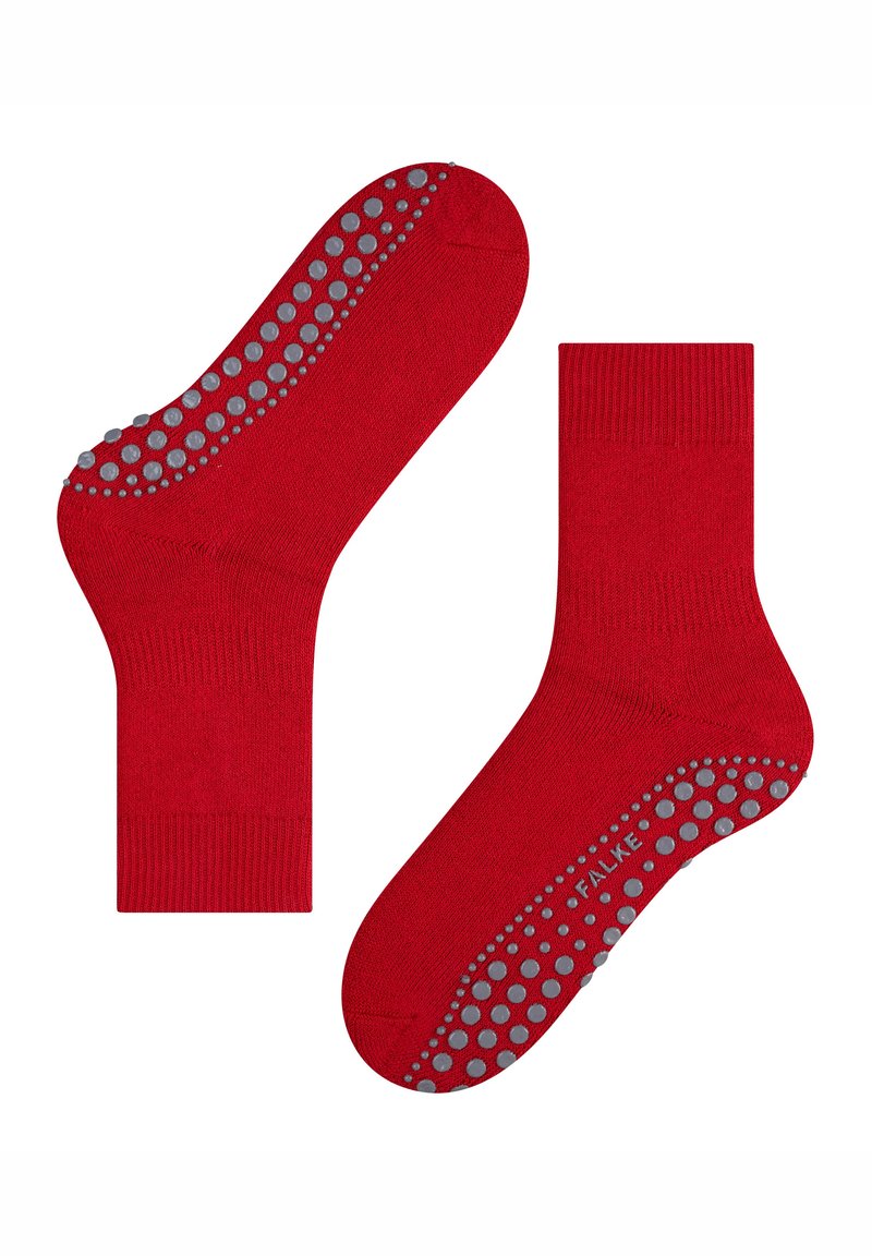 Calcetines rojos hasta el tobillo con puntos de goma antideslizantes en las suelas, que ofrecen agarre y estabilidad. Se muestran planos, con una suela hacia arriba y la otra hacia abajo.
