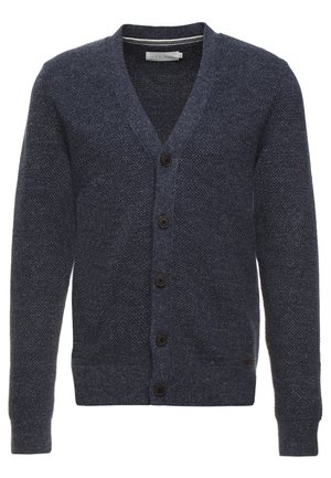 Cardigan bleu marine en tissu texturé, avec un col en V, des manches longues et cinq boutons marron à l'avant.