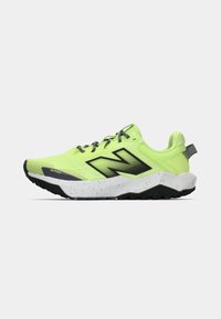 Running shoes in bright lime green with black accents, textured mesh upper, speckled white midsole, and rubber outsole for traction.