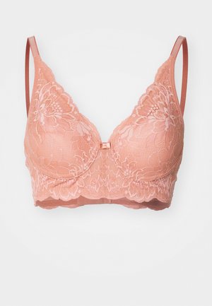 Bralette de encaje melocotón con un diseño floral, tirantes ajustables y un borde con ondas en la parte inferior. Presenta un pequeño lazo en el centro como adorno.