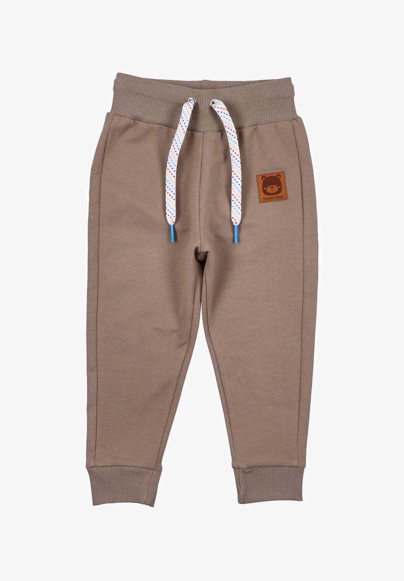 Bruine katoenen joggerbroeken met ribgebreide tailleband, witte en gekleurde trekkoorden en een beer-thema logo patch op de voorkant.