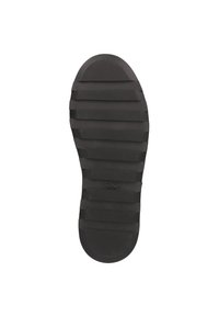 Schwarze Gummisohle mit Rillen und einer strukturierten Oberfläche für besseren Grip, mit einem geprägten runden Logo in der Mitte nahe der Ferse.