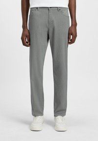 Gray patterned trousers with a straight fit, featuring a waistband with loops and subtle texture, paired with white sneakers.