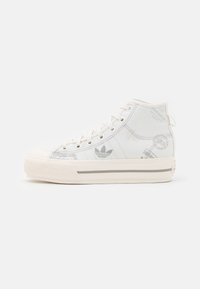 High-top sneakers made of white canvas with gray accents, featuring printed logos, textured toe cap, and ribbon-style laces.