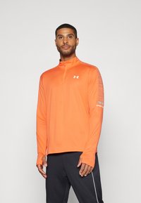 Long-sleeve, zip-up athletic shirt in bright orange. Features a high collar, thumbholes in sleeves, and a textured pattern along the shoulders.