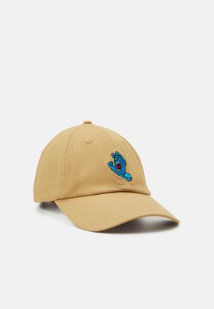 Beige Baseballkappe mit gebogenem Schirm und einer kleinen bestickten blauen Hand mit offenem Mund auf dem Vorderteil.