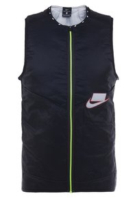 Veste sans manches noire avec fermeture éclair vert fluo à l'avant, col rond et logo Nike blanc entouré de rouge sur le côté gauche.