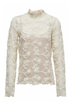 Blouse transparente à manches longues en rose pâle avec broderie florale blanche. Comprend un col montant à volants et un ourlet festonné.