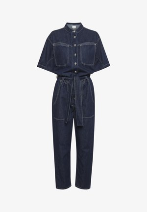 Jeansoveralls med krave, korte ærmer, to forlommer og belted talje. Mørkeblåt stof med kontrasterende syninger.