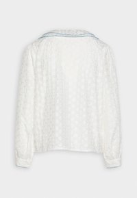 White long-sleeve blouse featuring a floral texture, a collared neckline with blue trim, and gathered sleeves with buttoned cuffs.