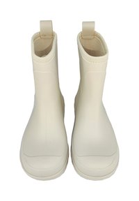 Bottines beiges en caoutchouc avec semelles texturées et languettes de tirage, présentant une surface lisse et un ajustement confortable autour des chevilles.