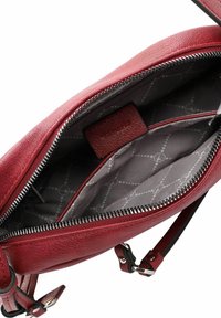 Borsa in pelle rossa con apertura con zip, dotata di un interno grigio a fantasia, una piccola tasca e spallacci regolabili.