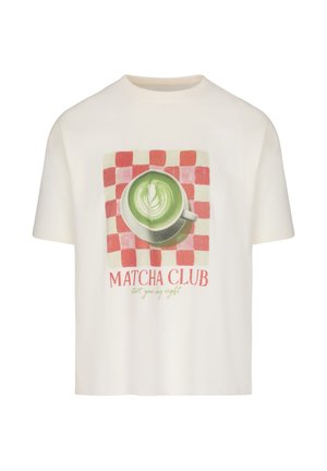 White t-shirt with print of green matcha latte in white cup on red checkered background, text "MATCHA CLUB start your day right" below.