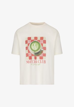 White t-shirt with print of green matcha latte in white cup on red checkered background, text "MATCHA CLUB start your day right" below.