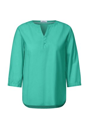 Turkoosi pusero, jossa on V-pääntie, kolme neljännestä hihoista ja neljän napin lista. Valmistettu sileästä kankaasta, jossa on rento ja väljä istuvuus.