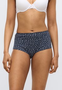 Παντελόνια υψηλής μέσης σε ναυτικό μ πλε με λουλουδάτο σχέδιο, κατασκευασμένα από μαλακό βαμβάκι, με ελαστική μέση και ανοίγματα στα πόδια για άνεση.