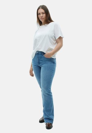 White cotton T-shirt paired with light blue denim flared jeans. The jeans feature a classic five-pocket design and medium wash.