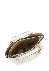 White textured leather handbag with a zip closure, interior pocket, and a beige lining. Features a decorative bow on the side.