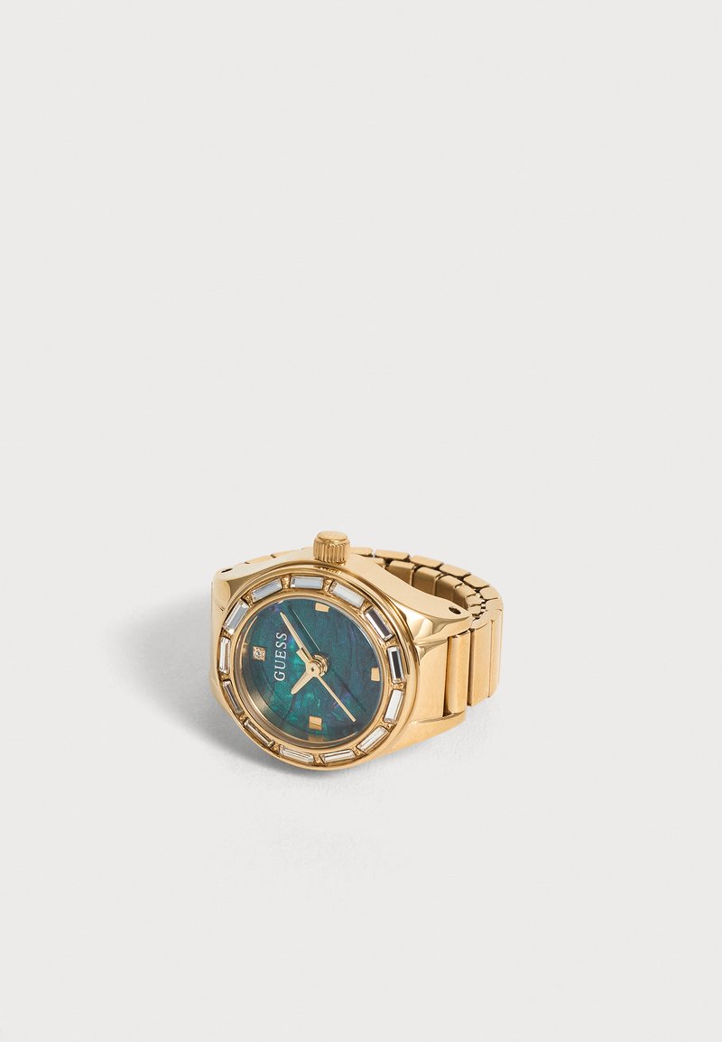Ρολόι χειρός Guess με χρυσαφένιο τόνο, μπλε-πράσινο υφασμάτινο καντράν και μεταλλικό μπρασελέ, δείχνει ώρες, λεπτά και δευτερόλεπτα.