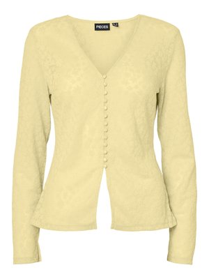 Blouse pour femme à manches longues de couleur jaune clair avec col en V et boutons recouverts de tissu sur le devant, légèrement cintrée à la taille.