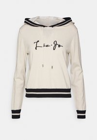 Sweat à capuche crème avec accents rayés noirs, texture douce, cordons de serrage réglables et logo "Liu Jo" brodé à l'avant.