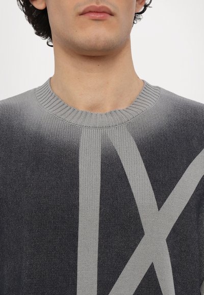 Grau gestrickter Pullover mit einem Farbverlauf, der ein großes hellgraues Grafikdesign zeigt. Gerippter Ausschnitt und weiche Textur.