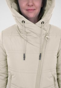 Lichtbeige pufferjack met een hoge kraag, verstelbare capuchon, zijrits en een gestructureerde stiksels aan de voorkant.