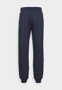 Marinblå sweatpants i mjukt material, med elastisk midja och mudd vid anklarna, med en avslappnad passform genom hela byxorna.