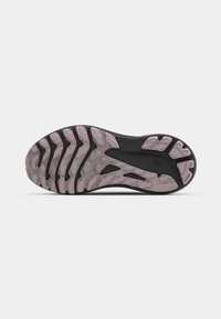 Black and light pink rubber shoe sole with textured tread pattern, featuring deep grooves and flex grooves for traction and flexibility.