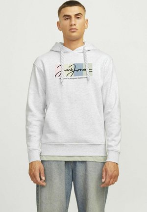 Gray hooded sweatshirt features a multi-colored block logo with "Jack Jones" text, drawstrings, and a kangaroo pocket, paired with light jeans.