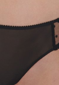 Black sheer lingerie with a scalloped lace trim, featuring polka dot mesh accents on the sides for added texture and detail.
