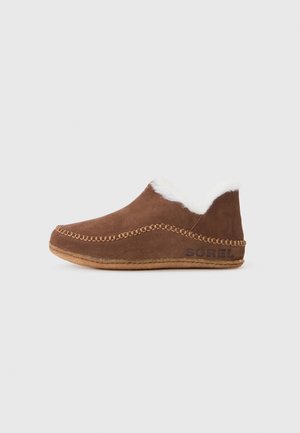 Brown suede slip-on slipper with white fur lining, whipstitch detailing, and rubber sole branded “SOREL” on the side.
