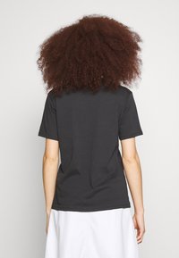 Black short-sleeve t-shirt made of smooth cotton, featuring a crew neckline and a relaxed fit, shown from the back with a plain design.