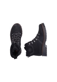 Black leather ankle boots with textured fur lining, metal eyelets, and thick rubber soles. Features a side zipper for easy wear.