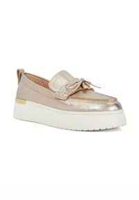 Metallic gold slip-on shoe featuring a textured surface, bow accent on the toe, and a white platform sole with a subtle gold detail.