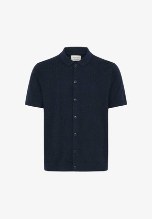 Navyblauw gebreid poloshirt met korte mouwen, een kraag, knoopsluiting aan de voorkant en geribbelde zoom en manchetten. Gemaakt van zachte, gestructureerde stof.