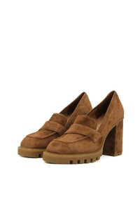 Mocassini in suede marrone con tacco alto a blocco, caratterizzati da un vamp cucito e una suola in gomma antiscivolo per una migliore aderenza.