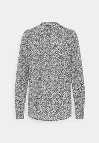 Camicia a maniche lunghe in bianco e nero con un motivo di punti sparsi, dotata di colletto e taglio dritto. Tessuto di finitura liscia.