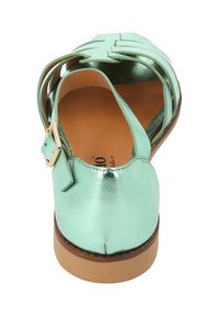 Sandalia de cuero metálico en verde menta, con detalle de correa y hebilla. Punta redondeada, tacón bajo y diseño de parte superior trenzada. Suela plana.