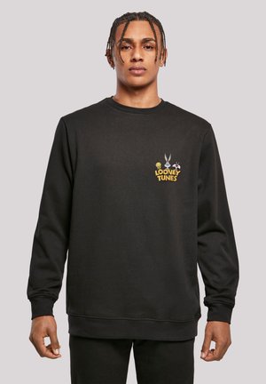 Schwarzer Hoodie mit einem kleinen Looney Tunes Grafik, die Charaktere und Text auf der Brust zeigt. Klassische Passform mit gerippten Bündchen und Saum.