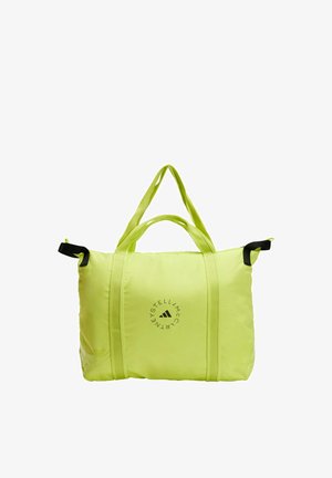 Bolsa tote de color verde neón con dos asas cortas, que presenta tiras de acento negras y un logo circular en la parte frontal. Material suave y duradero con un diseño espacioso.
