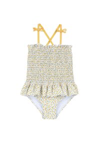 Maillot de bain une pièce floral jaune avec corsage froncé, bretelles croisées dans le dos et ourlet volanté à la jupe. Présente de petits motifs de feuilles vertes.