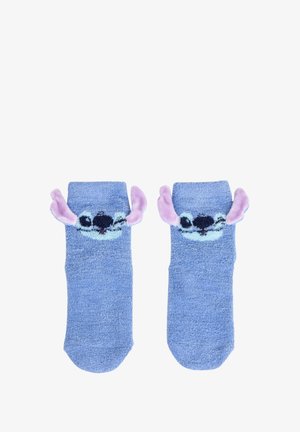 Chaussettes en peluche bleues avec le visage d'un personnage de dessin animé, ornées d'oreilles en tissu violet s'étendant du haut et d'une finition texturée.