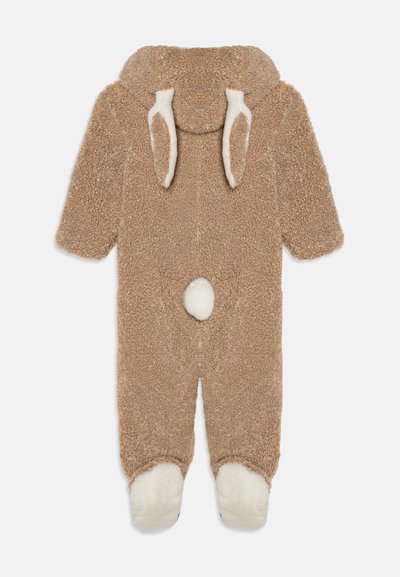 Brown fleece onesie with a hood featuring white ear accents, a round white tail, and white foot patches; soft, textured fabric.