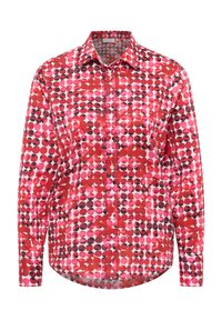 Rotes und pinkes Polka-Dot-Hemd mit Button-Down-Kragen und langen Ärmeln. Das Muster zeigt Kreise in verschiedenen Größen auf einem weißen Hintergrund.