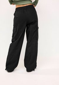 Next RIPS - Kareiviško stiliaus kelnės - black