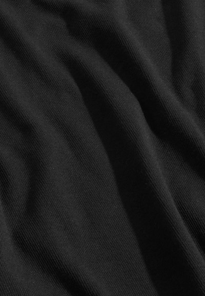 Schwarzer Stoff mit einer weichen Textur, der feine Rippung und sanfte Falten zeigt. Das Material wirkt leicht und glatt.