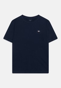 T-shirt en coton bleu marine avec un col rond, des manches courtes et un petit logo sur la poitrine. Texture douce et design à coupe standard.