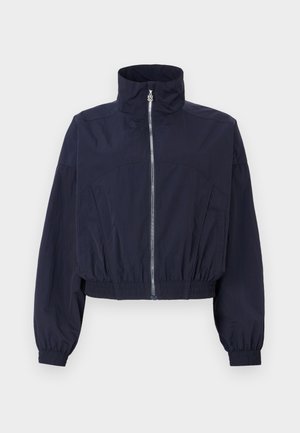 Navy cropped jacket, featuring a high collar, front zipper, elastic waistband, and gathered sleeves, made from lightweight, textured fabric.