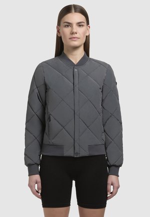 Gray quilted bomber jacket with a round collar, snap button closure, elastic cuffs, and waistband. Smooth texture, minimalistic design.